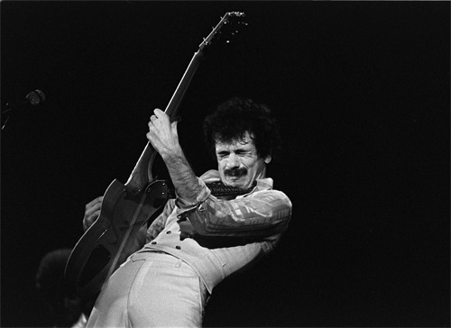 Rock guitarist Carlos Santana plays guitar on stage