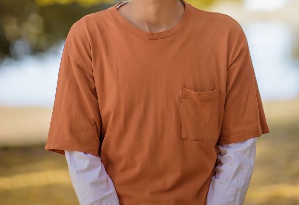 Orange T-shirt over a white long sleeve tee shirt